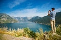 Tourist man taking a picture of the Bay of Kotor, Montenegro Royalty Free Stock Photo