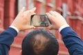 A tourist man is taking pictures on the phone in Red Square in Moscow. Royalty Free Stock Photo