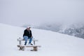 Tourist man travel to snowy mountains background Royalty Free Stock Photo