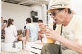 Tourist man trying a refreshing frozen drink of butia, in Cabo Polonio, Uruguay