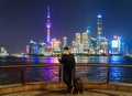 Tourist man using a smartphone near The Bund in Shanghai downtown, China in travel trip, vacation, or holidays concept in Asia.