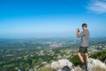 Tourist man on viewpoint at top of Jezerski mountain, near Njegos mausoleum at Cetinje city background. Lovcen National Park. Royalty Free Stock Photo