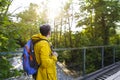 Tourist man walking across wooden bridge Royalty Free Stock Photo