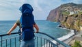 Camara de Lobos - Tourist man wearing baby carrier looking at Praia de Vigario in Camara de Lobos on Madeira island, Portugal