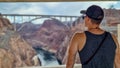 Hoover Dam - Tourist man wearing hat with scenic view of Mike O'Callaghan Pat Tillman Memorial Bridge, Nevada Arizona state line Royalty Free Stock Photo