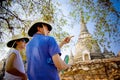 Tourist man and woman looking and point at the pagoda at Ayutthaya Historical Park