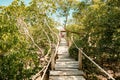 A tourist on the Mangrove boardwalk in Mida Creek in Watamu during the low tide in Malindi, Kenya