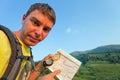 Tourist with a map and compass in the mountains of Switzerland. Royalty Free Stock Photo