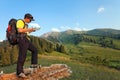 Tourist with a map and compass in the mountains of Switzerland. Royalty Free Stock Photo