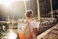 Tourist mature man standing with map and backpack near the sea Royalty Free Stock Photo