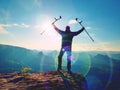 Tourist with medicine crutch above head achieve mountain peak. Hurt backpacker with broken leg Royalty Free Stock Photo