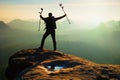 Tourist with medicine crutch above head achieved mountain peak. Hiker with broken leg in immobilizer. Royalty Free Stock Photo