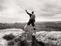 Tourist with medicine crutch above head achieved mountain peak. Hiker with broken leg Royalty Free Stock Photo