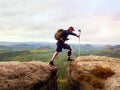 Tourist with medicine crutch above head achieved mountain peak. Hiker with broken leg Royalty Free Stock Photo