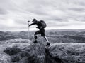 Tourist with medicine crutch above head achieved mountain peak. Hiker with broken leg Royalty Free Stock Photo