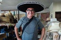 Tourist with Mexican sombrero cow boy hat shop