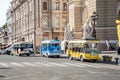 Tourist mini buses near the opera house in the rays of the autumn sun