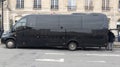 Tourist minibus black waiting with rear door open parking in tour street