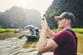 Tourist with mobile phone on boat Royalty Free Stock Photo