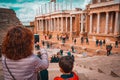 Tourist mother and child taking a picture in the antique Roman Theatre of Merida, Spain. Royalty Free Stock Photo