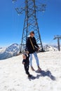 Tourist mother and little son on the snowy slope of mountain Elbrus in Russia