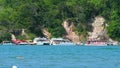 Tourist boats at Guadeloupe beach for the clay bath