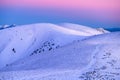 Tourist on the mountains ridge walking on the road in winter landscape Royalty Free Stock Photo