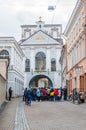 Tourist near the Gate of Dawn in Vilnius, the chapel of Our Lady of the Gate of Dawn is in the middle behind the glass window.