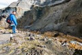 Tourist near stream in gorge in Landmannalaugar