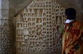 Tourist near Tirthankara scupltures. Jain temple. Ranakpur. Rajasthan. India