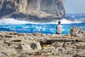 Tourist observe the rough seas of Dwejra Bay in Gozo, Malta