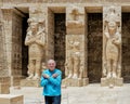 Tourist & Osiride statues of Ramesses III being attended to by little queens on the right side of the first court of his Temple.