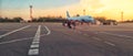 Tourist passager getting in to airplane at airport, walking from the terminal to the plane