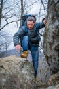 Tourist on the peak of high rocks. Sport and active life concept