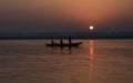 Tourist people on wooden boat at Ganges river at sunrise. Varanasi India Royalty Free Stock Photo