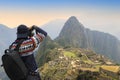 tourist and photographer taking photo at Machu Picchu, one of seven wonders and famous tourist attraction in Cusco Region of Peru