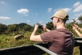 Tourist is photographing of herd of wild elephants