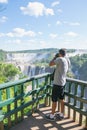 Tourist photographing the Iguassu Falls, in Foz do IguaÃÂ§u.