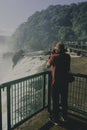 Tourist photographing the Iguassu Falls, in Foz do IguaÃÂ§u.