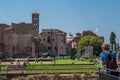 Tourist photographing the Temple of Venus and Rome seen from the Coliseum in Rome, Italy