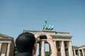 Tourist photographs on a mobile phone the Brandenburg Gate in Berlin in Germany.