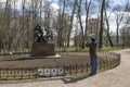 The tourist photographs a monument to Alexander Sergeevich Pushkin in Tsarskoe Selo, St. Pet