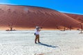 Tourist photographs a orange dunes Royalty Free Stock Photo