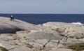 Tourist photographs the rocky coast of Peggy's Cove Nova Scotia September 2014. Royalty Free Stock Photo