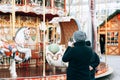 A tourist photographs a traditional holiday carousel at the Christmas Fair in Berlin