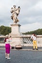 A tourist photographs the violinist. Rome, Italy