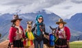 Tourist picturing with Peruvian and llama