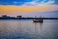 Tourist pirate ship floats on the Dnieper river in Dnipro Ukraine at sunset. Vintage boat in the water against the background of Royalty Free Stock Photo