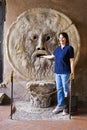 Tourist placing hand in Mouth of Truth Bocca della Verita