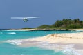 Tourist plane flying over Caribbean beach Royalty Free Stock Photo